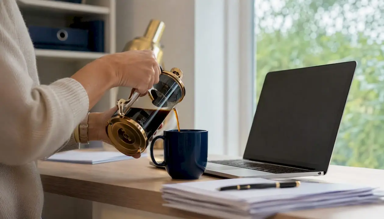 Hand pouring coffee by organizer and calculator