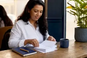Hands sorting receipts on home office desk