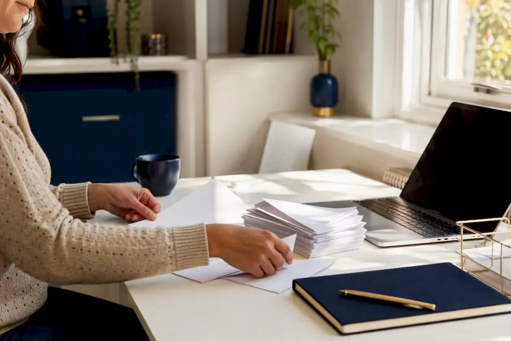 Hands sorting payroll paperwork on desk