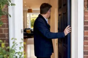 UK homeowner at main residence doorway